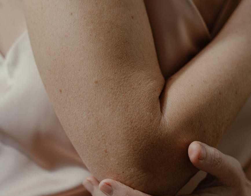 a woman touching her elbow